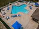 Aerial view of community pool featuring a clover-shape design and many lounge chairs at 2629 Timacqua Dr, Holiday, FL 34691