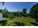 Private backyard with lush greenery and an outdoor space for relaxation and recreation at 2629 Timacqua Dr, Holiday, FL 34691