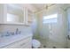 Bathroom features a shower with glass door, and white vanity at 2629 Timacqua Dr, Holiday, FL 34691
