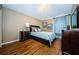 Comfortable bedroom featuring hardwood floors and ample natural light at 2629 Timacqua Dr, Holiday, FL 34691