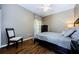 Cozy bedroom with a full-sized bed, chair, dresser, and a ceiling fan at 2629 Timacqua Dr, Holiday, FL 34691
