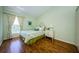 Bright bedroom with hardwood floors, a large window, and neutral wall color at 2629 Timacqua Dr, Holiday, FL 34691