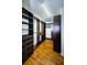 Custom walk-in closet with wooden organizers and ample storage on wood floors at 2629 Timacqua Dr, Holiday, FL 34691