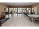 Key Vista Clubhouse interior with tables, chairs, double doors to exterior pool, and seating at 2629 Timacqua Dr, Holiday, FL 34691