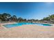 Inviting community pool area with ample lounge chairs and beautifully landscaped surroundings for relaxation at 2629 Timacqua Dr, Holiday, FL 34691