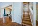 Inviting entryway featuring hardwood floors, staircase, and open access to the dining and living area with blue accents at 2629 Timacqua Dr, Holiday, FL 34691