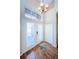 Bright foyer features wood floors, high ceilings, and elegant lighting fixture at 2629 Timacqua Dr, Holiday, FL 34691