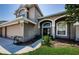 Elegant front entrance with arched windows and a meticulously landscaped walkway at 2629 Timacqua Dr, Holiday, FL 34691