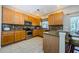 Well-lit kitchen featuring wood cabinets, granite countertops, and stainless steel appliances at 2629 Timacqua Dr, Holiday, FL 34691