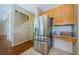 Bright kitchen features a stainless steel refrigerator and tiled flooring at 2629 Timacqua Dr, Holiday, FL 34691