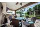 Enclosed lanai featuring comfortable seating and outdoor kitchen perfect for entertaining guests at 2629 Timacqua Dr, Holiday, FL 34691