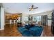 Open-concept living room with a large sectional, ceiling fan, and hardwood floors at 2629 Timacqua Dr, Holiday, FL 34691