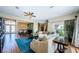 Open living space with ample seating, a ceiling fan, and a dining area beyond at 2629 Timacqua Dr, Holiday, FL 34691