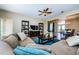 Spacious living room with a large sectional sofa, ceiling fan, and a dining area at 2629 Timacqua Dr, Holiday, FL 34691