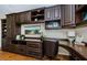Close up shot of a custom built-in shelving and desk unit with hardwood floors and a leather chair at 2629 Timacqua Dr, Holiday, FL 34691