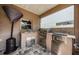 An outdoor kitchen features granite countertops, a stainless steel BBQ, and tile flooring at 2629 Timacqua Dr, Holiday, FL 34691