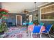 Charming covered patio with colorful decor, hanging plants, and outdoor seating, great for entertaining at 2805 Olavet Ct, Valrico, FL 33596