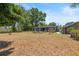 Large backyard featuring a well-maintained lawn and a charming exterior view of the home at 2805 Olavet Ct, Valrico, FL 33596