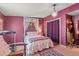 Cozy bedroom featuring purple walls, decorative chandelier, and comfortable furnishings at 2805 Olavet Ct, Valrico, FL 33596
