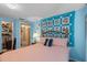 Light blue bedroom with a red and white quilt and an en suite bathroom at 2805 Olavet Ct, Valrico, FL 33596