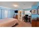 Bright blue bedroom with an en suite bathroom and a dedicated workspace at 2805 Olavet Ct, Valrico, FL 33596