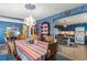 Bright dining room with chandelier, colorful striped tablecloth, and blue accent wall at 2805 Olavet Ct, Valrico, FL 33596