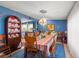 The dining area is decorated with a stylish hutch and chandelier, adjacent to the kitchen for easy access at 2805 Olavet Ct, Valrico, FL 33596
