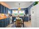 Bright kitchen with views from the windows, blue cabinets, tile floors, and white appliances at 2805 Olavet Ct, Valrico, FL 33596