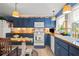 Charming kitchen with blue cabinets, butcher block countertops, and an eat-in table at 2805 Olavet Ct, Valrico, FL 33596