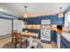 Kitchen features blue cabinets, tile floors, breakfast nook and white appliances at 2805 Olavet Ct, Valrico, FL 33596