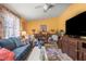 Cozy living room showcasing comfortable seating, vintage decor, and a large television at 2805 Olavet Ct, Valrico, FL 33596
