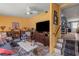Inviting living room featuring a large television, comfortable seating, and access to the staircase at 2805 Olavet Ct, Valrico, FL 33596