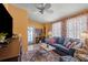 Bright living room with vintage furniture, floral curtains, and a glass paneled front door at 2805 Olavet Ct, Valrico, FL 33596