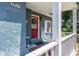 The front porch with a red door, adorned with a wreath, creating an inviting entry to this home at 2805 Olavet Ct, Valrico, FL 33596