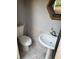 Powder bathroom with a pedestal sink, tiled flooring, and modern toilet at 2903 N 16Th St, Tampa, FL 33605