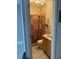 Cozy bathroom including a shower with brown curtain, a vanity and tile flooring at 2903 N 16Th St, Tampa, FL 33605
