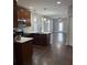 Kitchen featuring dark wood cabinets, stainless appliances, and a stylish mosaic backsplash at 2903 N 16Th St, Tampa, FL 33605