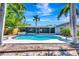 A beautiful in-ground pool and hot tub with privacy fence, perfect for relaxation and outdoor enjoyment at 3044 Golden Rain Dr, Sarasota, FL 34232