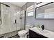 Updated bathroom with walk-in shower featuring stunning tile work, modern fixtures, and a dark vanity at 3044 Golden Rain Dr, Sarasota, FL 34232
