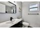 Modern bathroom features a sleek vanity, contemporary mirror, and stylish fixtures at 3044 Golden Rain Dr, Sarasota, FL 34232