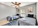 Bright bedroom features two beds, cool ceiling fan, and a large window at 3044 Golden Rain Dr, Sarasota, FL 34232