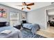 Charming bedroom features two twin beds, ceiling fan, natural light, and stylish decor at 3044 Golden Rain Dr, Sarasota, FL 34232