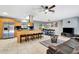 Open-concept kitchen with an island, bar stools, and stainless steel range hood seamlessly blending with the living area at 3044 Golden Rain Dr, Sarasota, FL 34232