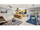 Open-concept kitchen featuring an island with bar seating, stainless appliances, and seamless flow into the living area at 3044 Golden Rain Dr, Sarasota, FL 34232