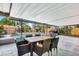Screened patio with dining table and chairs overlooking the sparkling pool at 3044 Golden Rain Dr, Sarasota, FL 34232