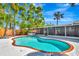 Inviting backyard with a sparkling pool, spa, screened in porch, and lush landscaping creating a private oasis at 3044 Golden Rain Dr, Sarasota, FL 34232