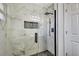 Modern bathroom showcases a sleek glass shower with stylish black fixtures and marble-like tile at 3044 Golden Rain Dr, Sarasota, FL 34232