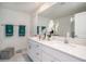 Bright bathroom boasts double vanity with white cabinets, and a large mirror at 32091 S Pop Ash N Pl, San Antonio, FL 33576