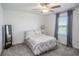 Neutral bedroom features gray carpet, ceiling fan, and matching bedding at 32091 S Pop Ash N Pl, San Antonio, FL 33576