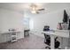 Bright bedroom with a ceiling fan and two white tables that could be used as desks at 32091 S Pop Ash N Pl, San Antonio, FL 33576